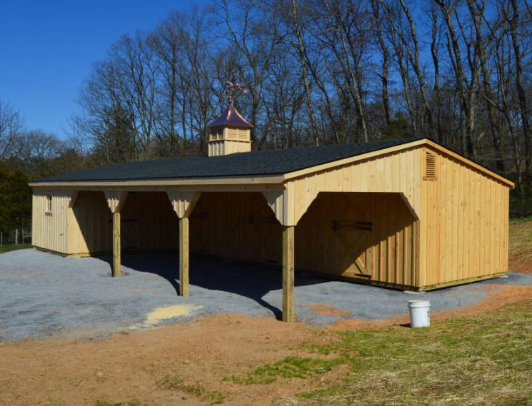 Red single story center aisle custom barn