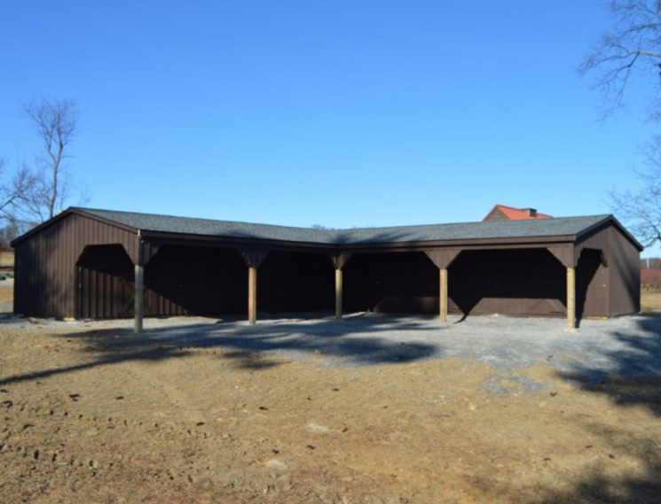 Red single story center aisle custom barn