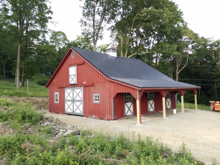 Horse barn large in size and with a red exterior