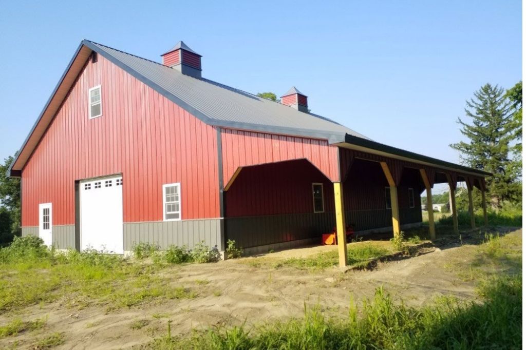 Spacious two-tone garage with overhang and metal roof
