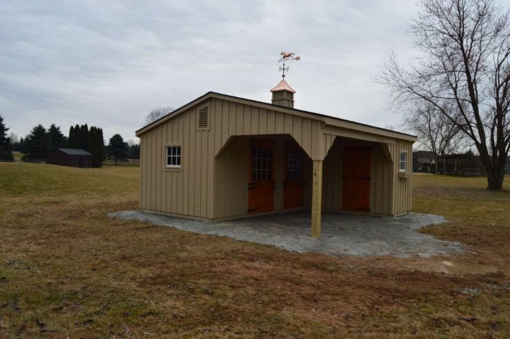 custom wood barns shed row with trees in the far background