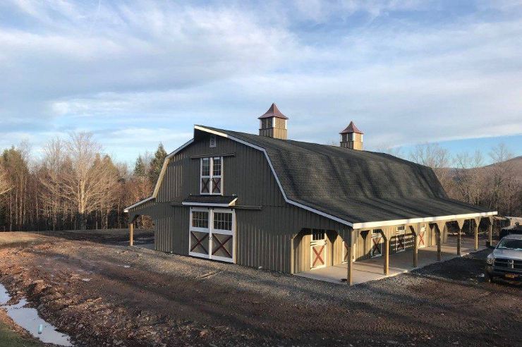 wooden horse barns gambrel large model in front of trees in winter