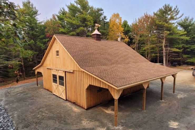 wooden horse barns high country in front of forest