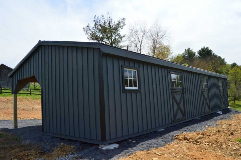 black l shaped horse barn