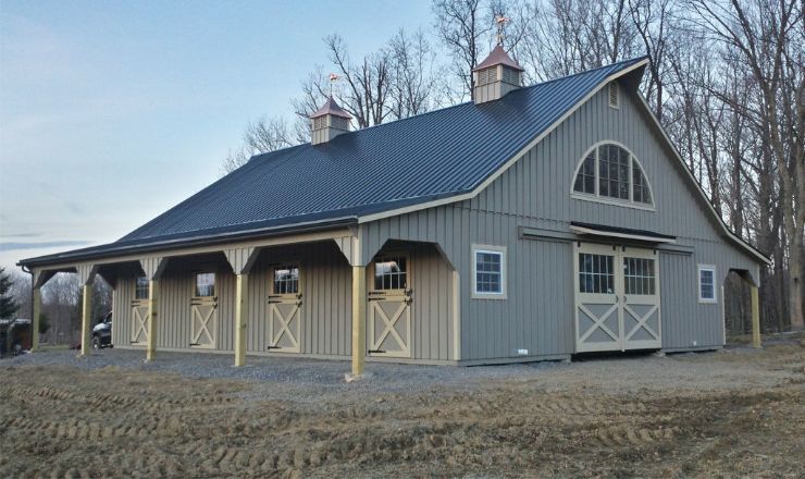 Light gray horse barn with white trim