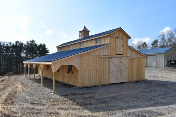 Two story horse barn with wooden siding