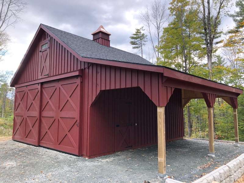 red barn with sliding doors and lean-to