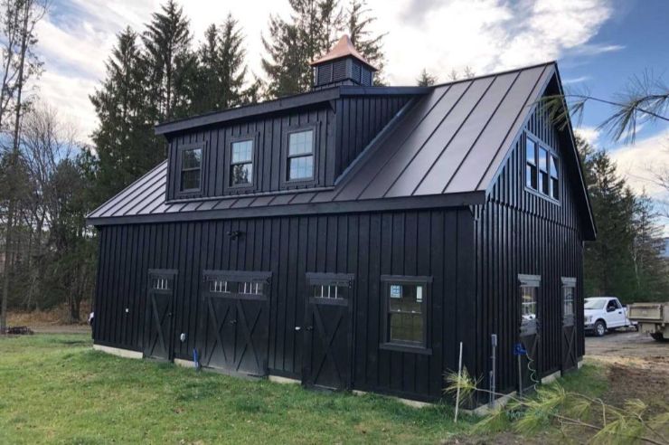 all black horse barn and garage combo