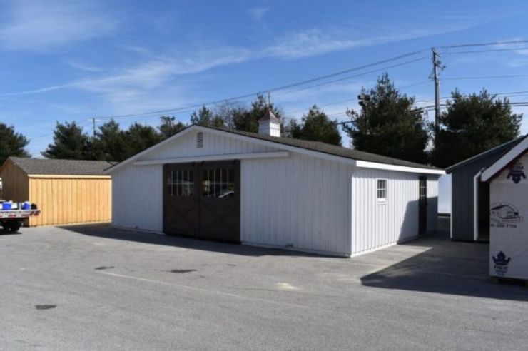 white trailside style barn with black doors