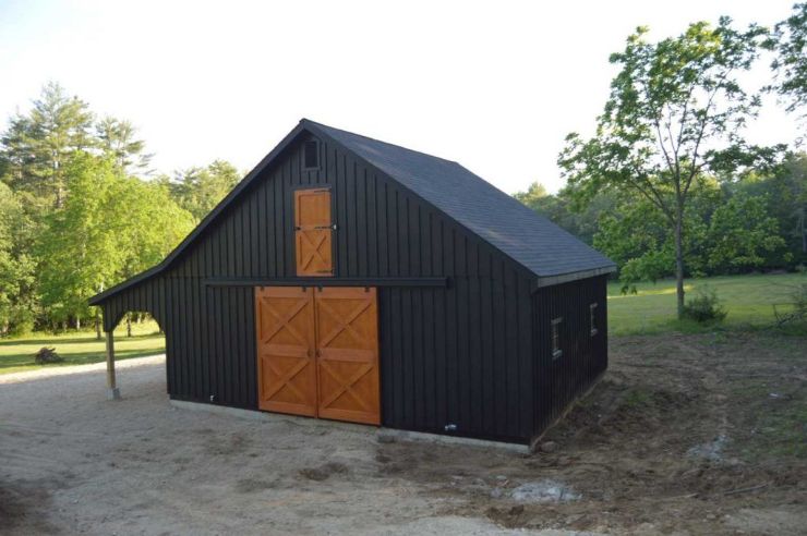 black and wood horse barn in a modern design