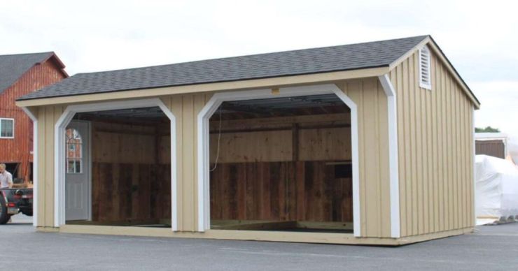 quaker style garage with two garage doors and a side access door in a parking lot