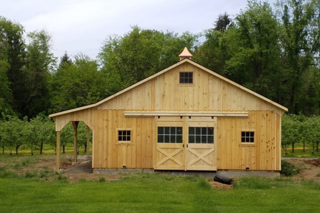 A two-story center aisle horse barn