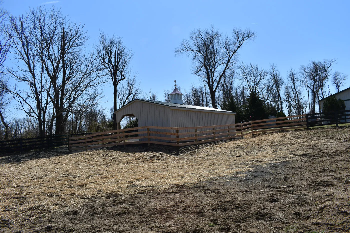 run-in shed with lean-to and green metal roof