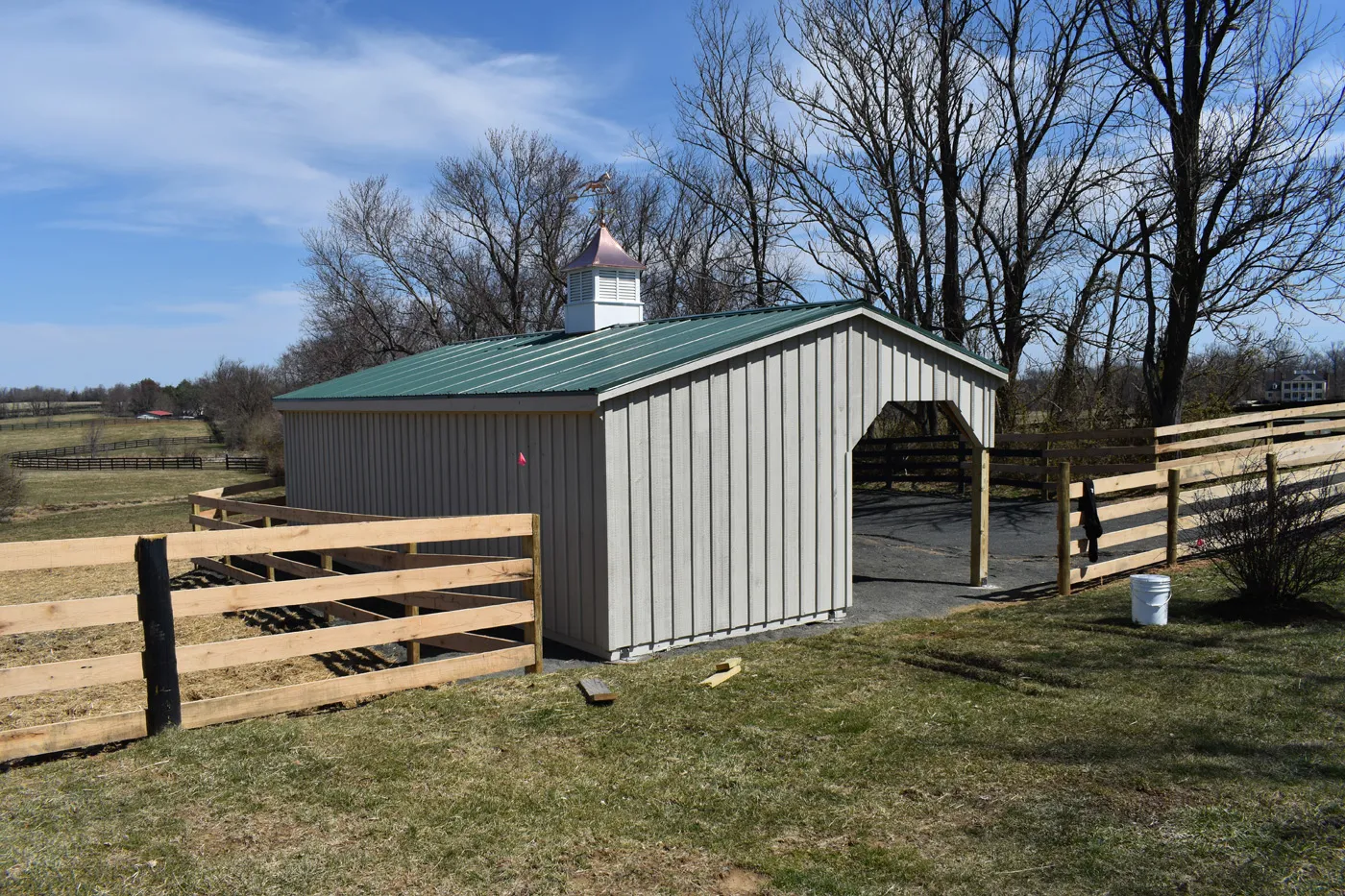 run-in shed with lean-to and green metal roof