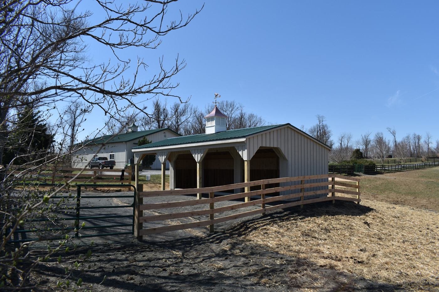 run-in shed with lean-to and green metal roof
